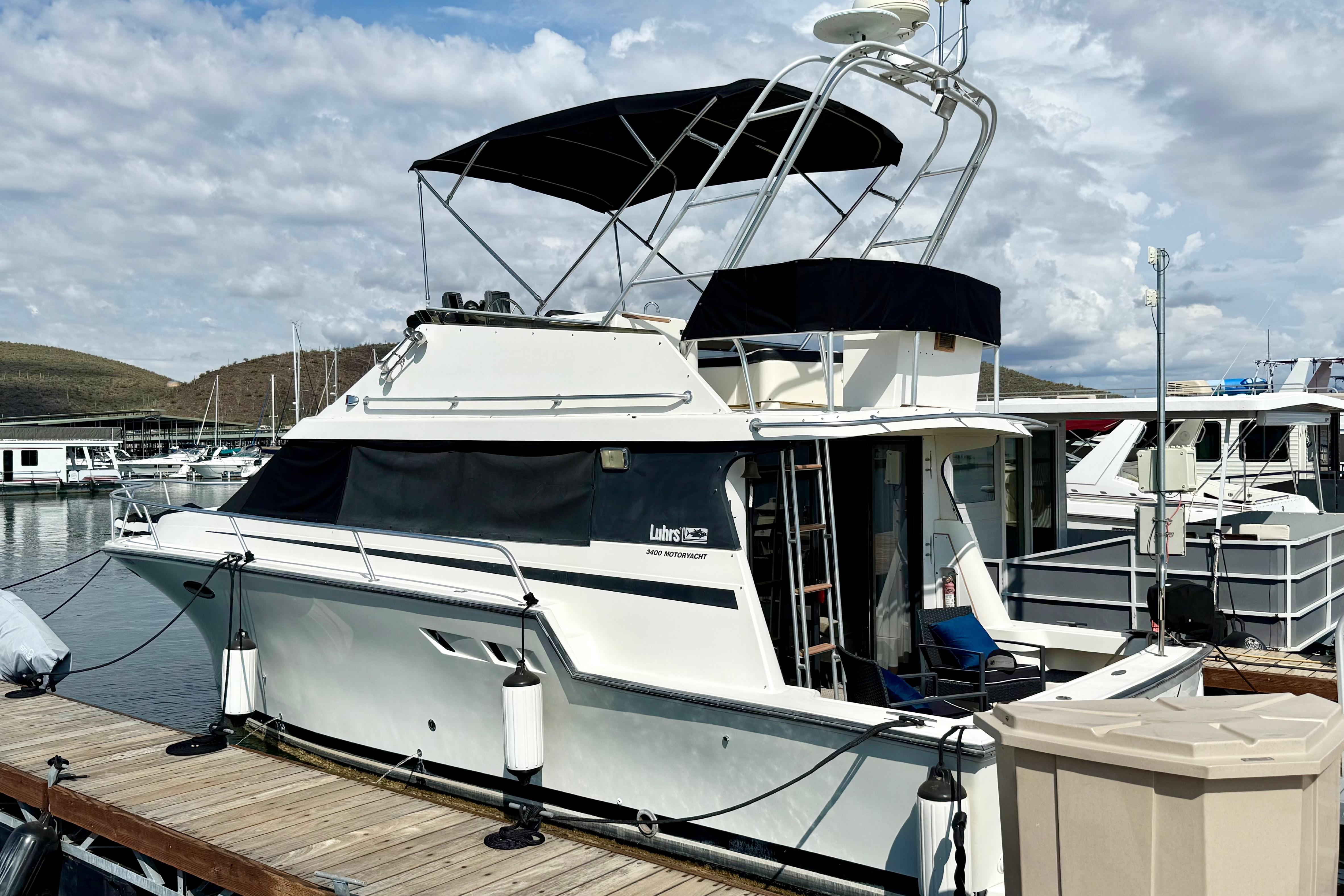 Luhrs 3400 Motor Yacht 1990 Luhrs 3400 Motor Yacht docked at marina under cloudy sky.