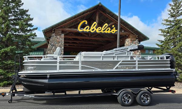 Ranger Reata 220F 2024 Ranger Reata 220F pontoon boat on trailer outside Cabela's store.