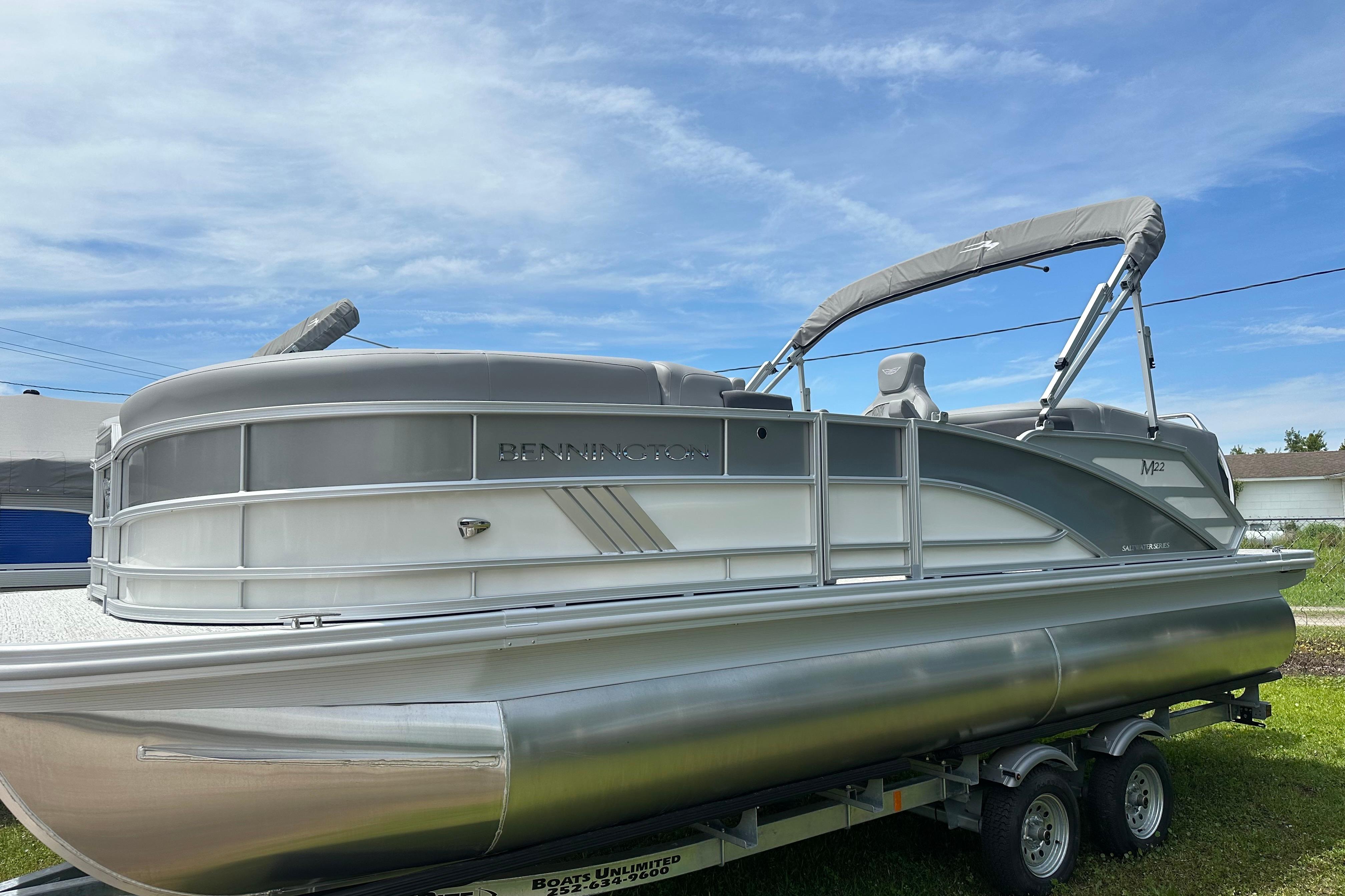 Bennington 22M 2025 Bennington 22M pontoon boat on trailer under clear blue sky.