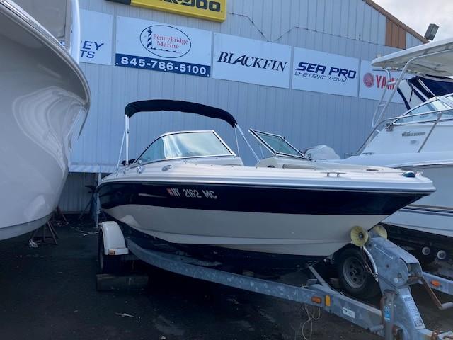 Sea Ray 185 Sport 2005 Sea Ray 185 Sport boat on trailer, parked at a marina with signage.