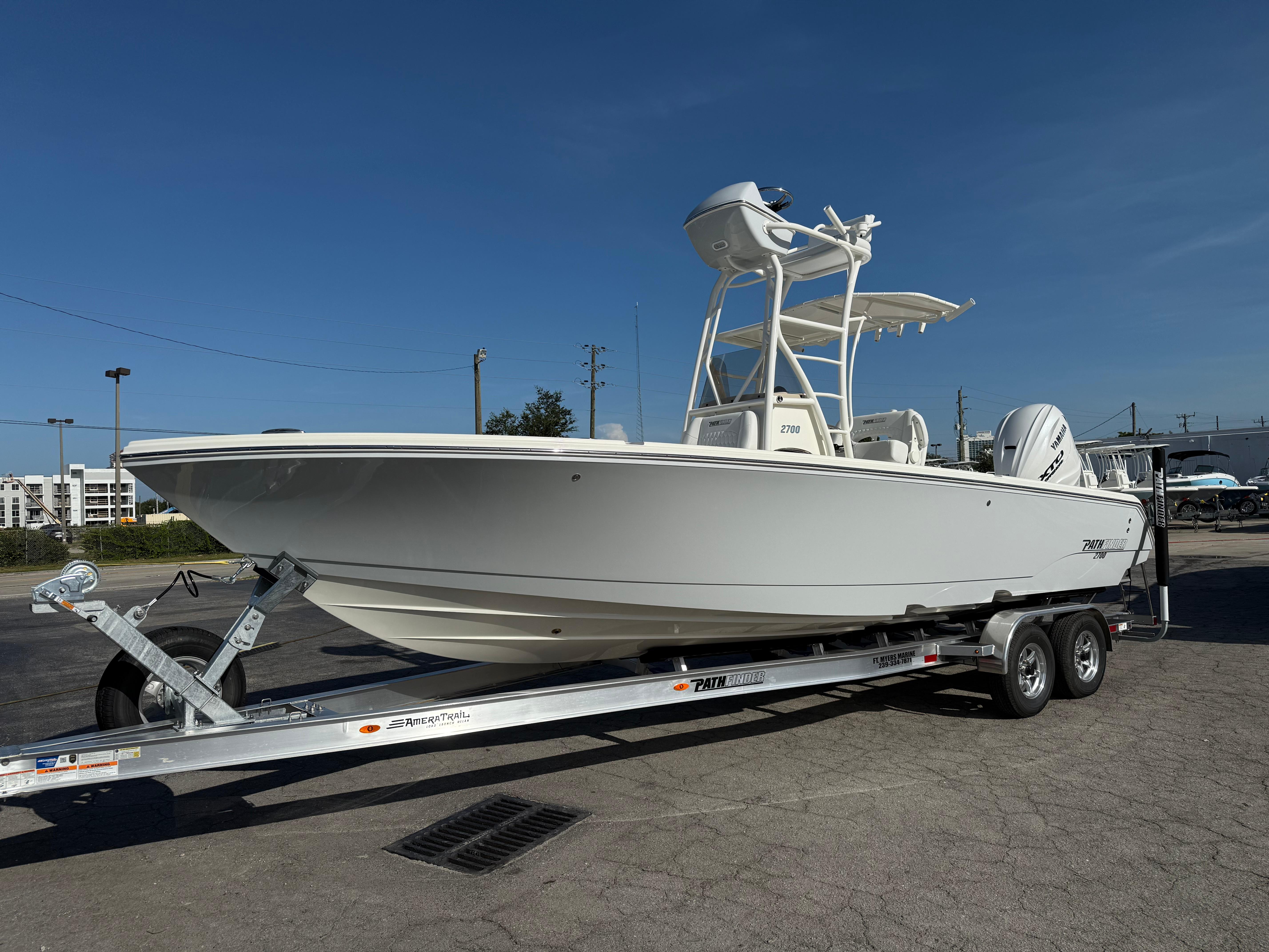 Pathfinder 2700 Open 2026 Pathfinder 2700 Open boat on trailer under clear blue sky.