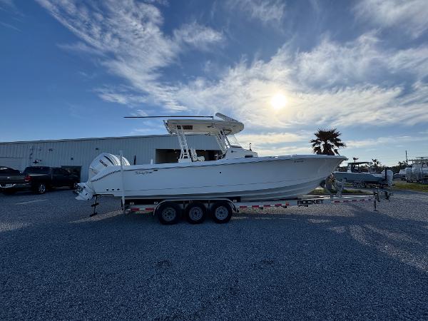 Edgewater 320CC 2017 Edgewater 320CC boat on trailer under a bright sky.