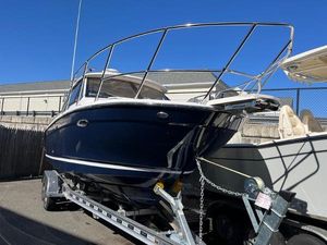 Cutwater C-248 C (COUPE) 2025 Cutwater C-248 C Coupe boat on trailer, blue hull, parked outdoors.