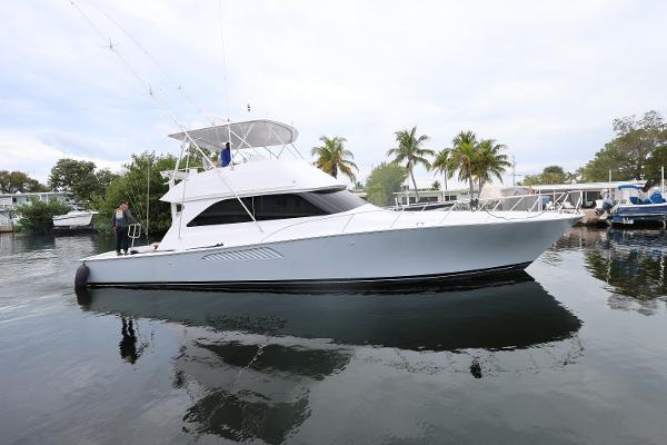 Viking 52 Convertible 2005 Viking 52 Convertible yacht docked in a serene marina setting.