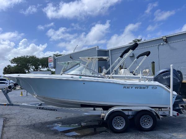 Key West 203 DFS 2025 Key West 203 DFS boat on trailer, parked outdoors under cloudy sky.