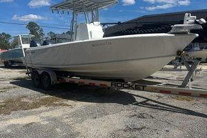 Contender 25 Open 2021 Contender 25 Open boat on a trailer, parked outdoors under a clear sky.