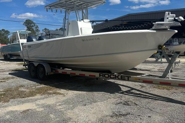Contender 25 Open 2021 Contender 25 Open boat on a trailer, parked outdoors under a clear sky.