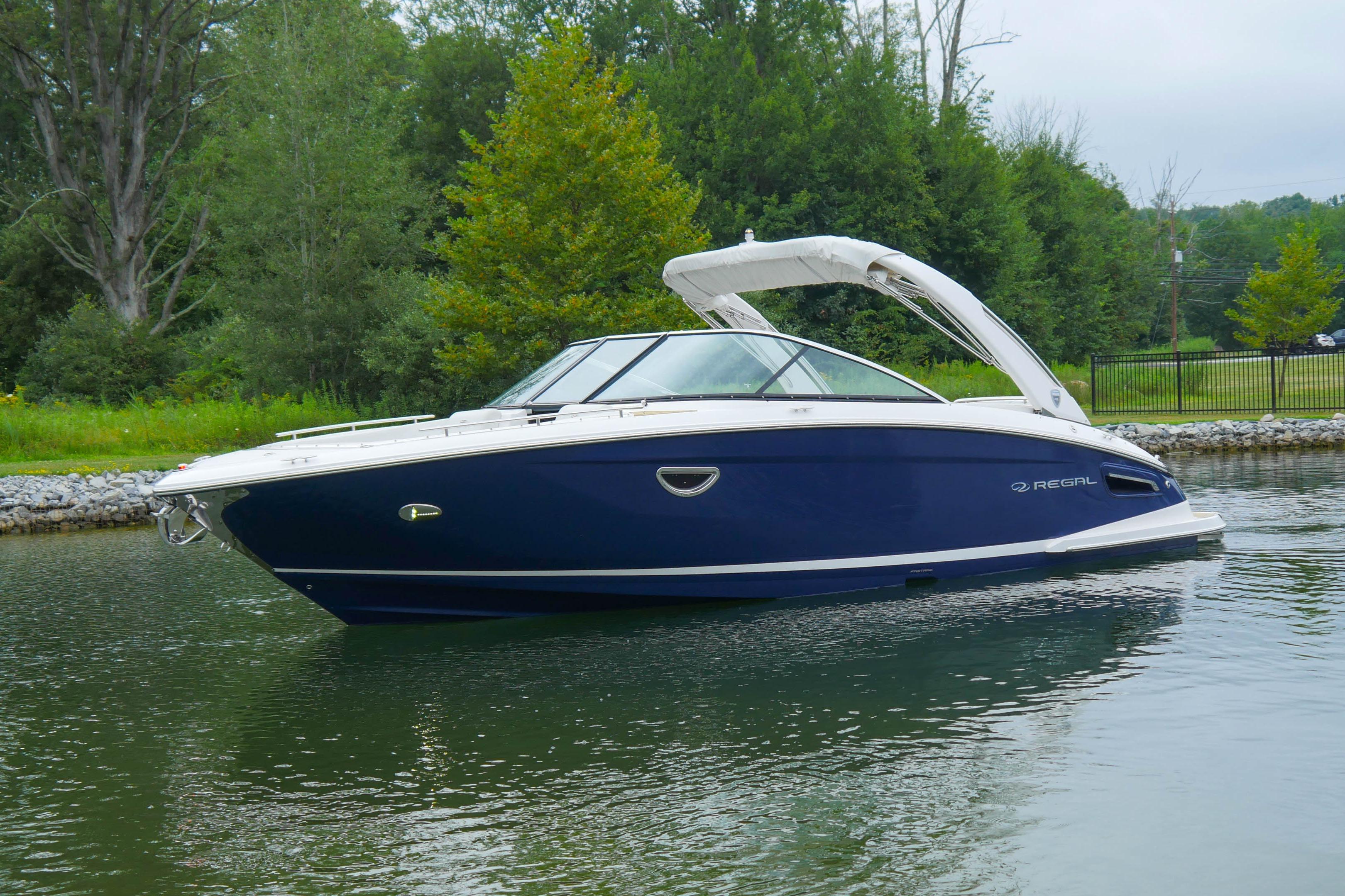 Regal 2800 Bowrider 2018 Regal 2800 Bowrider boat on calm water, surrounded by lush greenery.