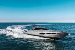 Pershing 8X 2019 Pershing 8X yacht cruising on open sea under clear blue sky.