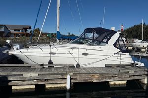 Cruisers Yachts 2870 Express 2000 Cruisers Yachts 2870 Express docked at marina under clear blue sky.