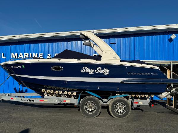Chaparral 257 SSX 2020 Chaparral 257 SSX boat on trailer in front of blue marine building.