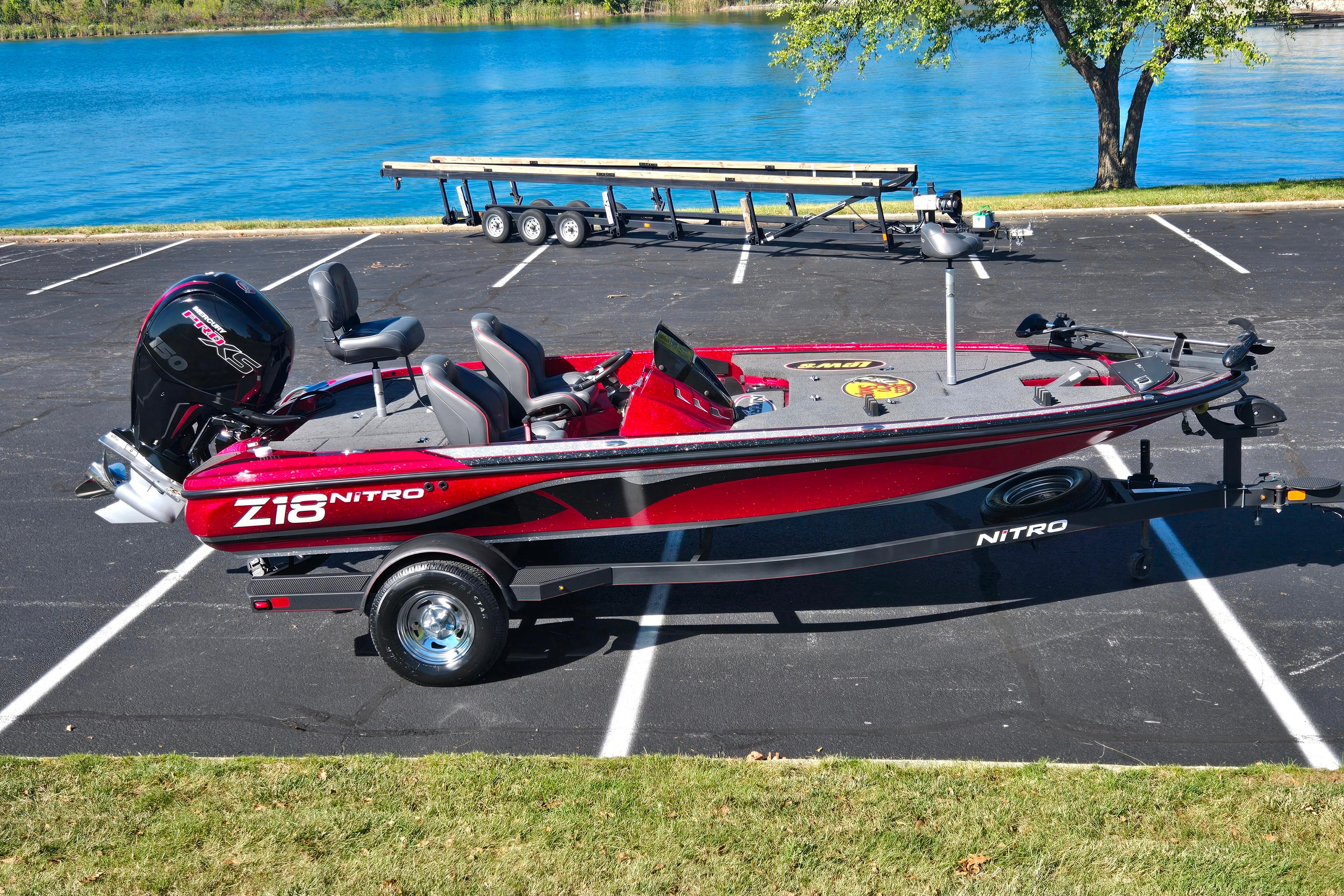Nitro Z18 Pro Red 2022 Nitro Z18 Pro boat parked near a lake with a trailer.