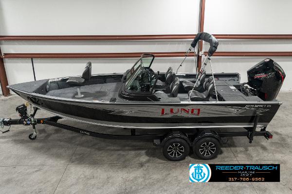 Lund 2075 IMPACT XS 2025 Lund 2075 IMPACT XS boat in showroom, side view, on trailer.