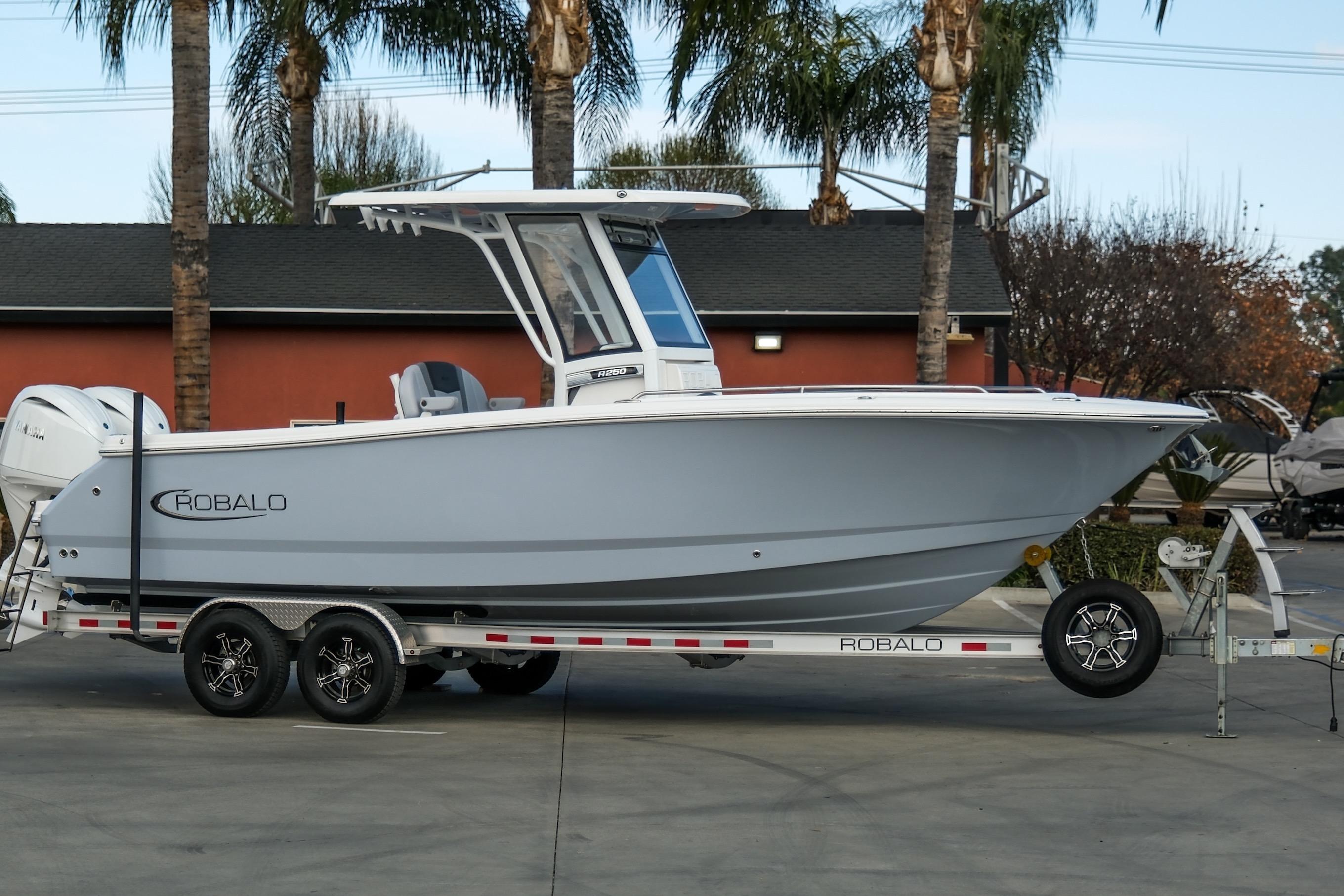 Robalo R250 Center Console 2025 Robalo R250 Center Console boat on trailer, parked outdoors.