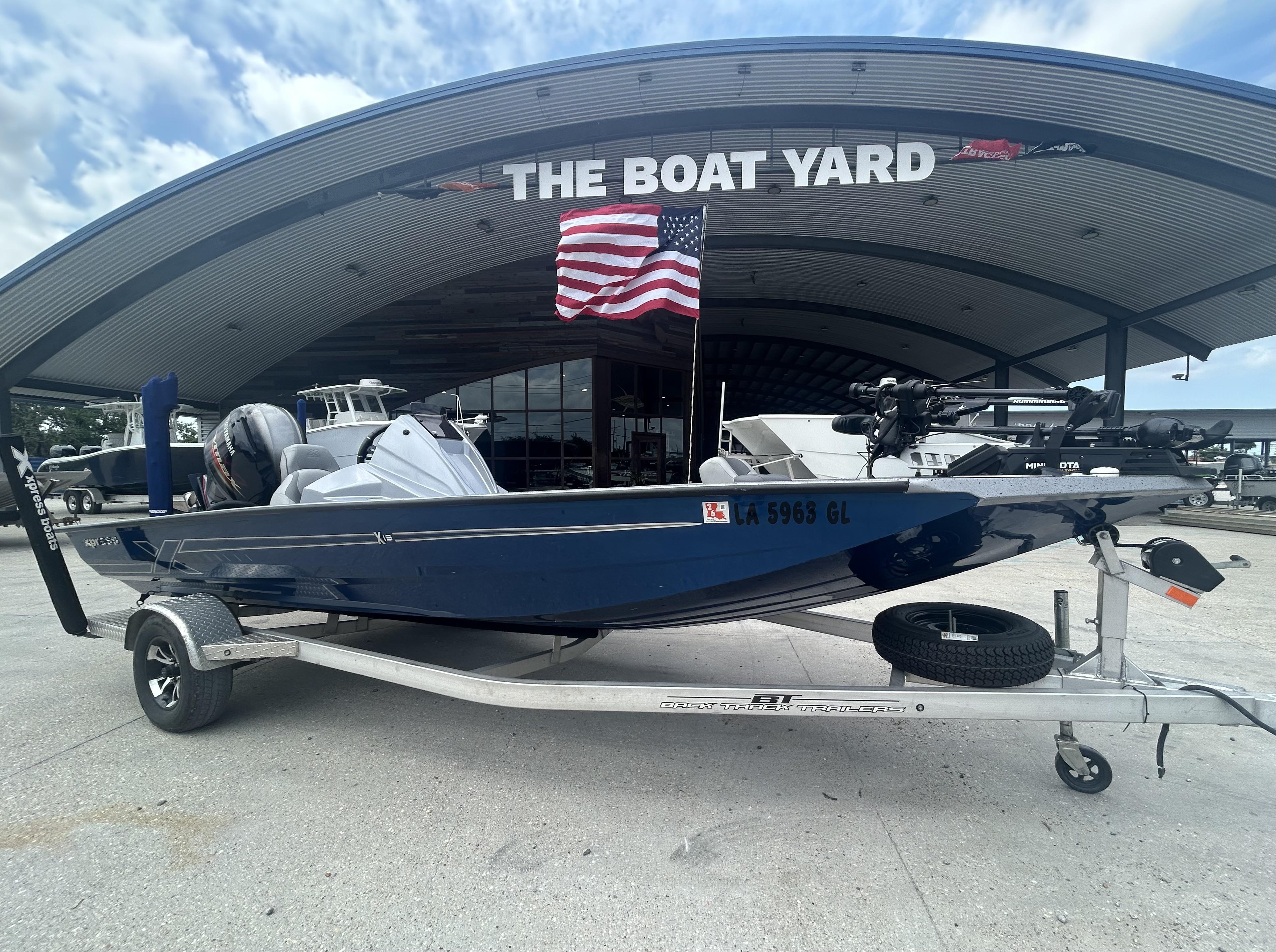 Xpress X19 Pro 2021 Xpress X19 Pro boat on trailer at The Boat Yard with American flag.