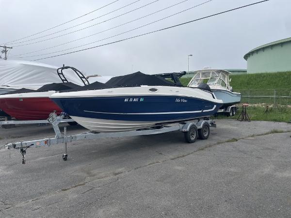 Bayliner VR6 Bowrider OB 2021 Bayliner VR6 OB boat on a trailer in a marina.