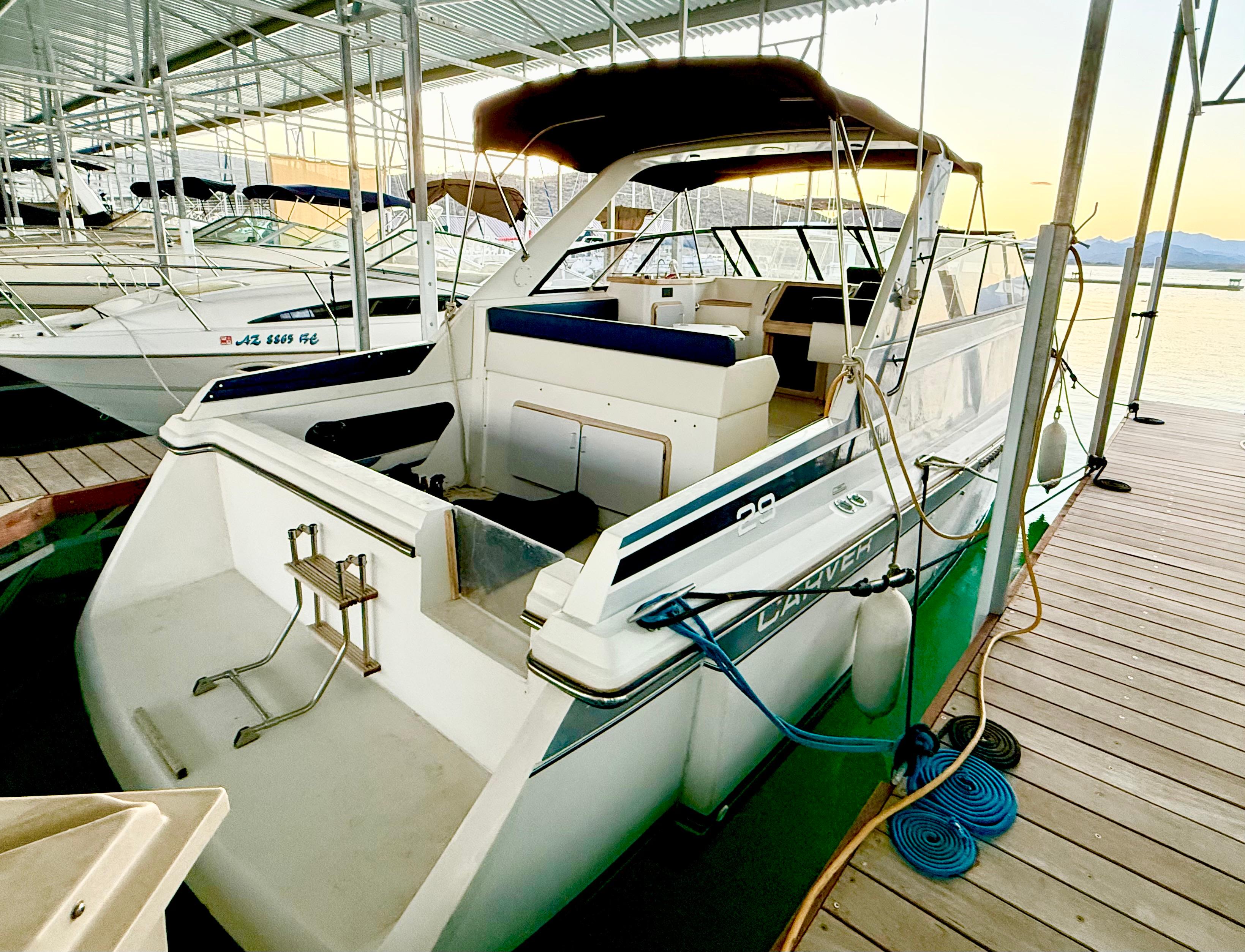 Carver 29 Monterey 1986 Carver 29 Monterey boat docked in a marina at sunset.