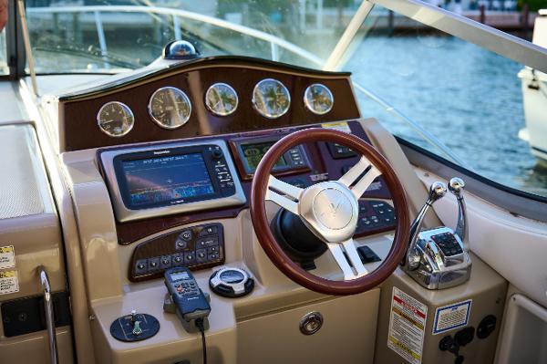 Sea Ray 330 Sundancer Dashboard of a 2012 Sea Ray 330 Sundancer boat with steering wheel and navigation instruments.