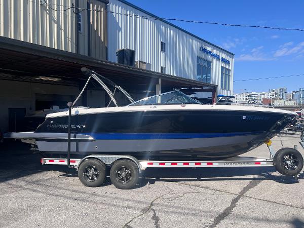 Chaparral 267 SSX 2022 Chaparral 267 SSX boat on a trailer outside a warehouse.