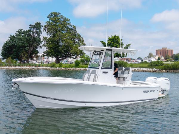 Regulator 23 2025 Regulator 23 boat on calm water, featuring sleek design and modern amenities.