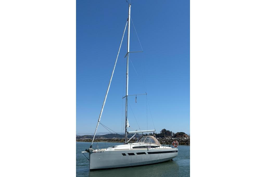 Jeanneau Sun Odyssey 349 2021 Jeanneau Sun Odyssey 349 sailboat on calm water under clear blue sky.