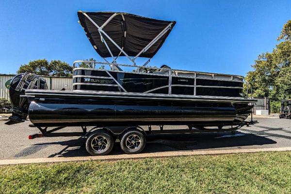 Ranger Reata 223C 2024 Ranger Reata 223C pontoon boat on trailer, black exterior, parked outdoors.