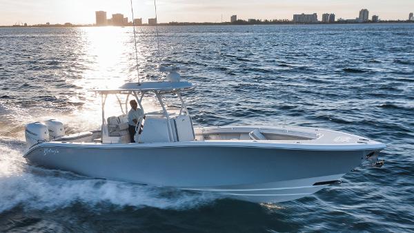 Yellowfin 32 Offshore 2026 Yellowfin 32 Offshore boat cruising on ocean at sunset.