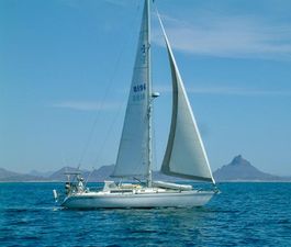 Islander IP Peterson 40 1979 Islander IP Peterson 40 sailboat cruising on open water with distant mountains.