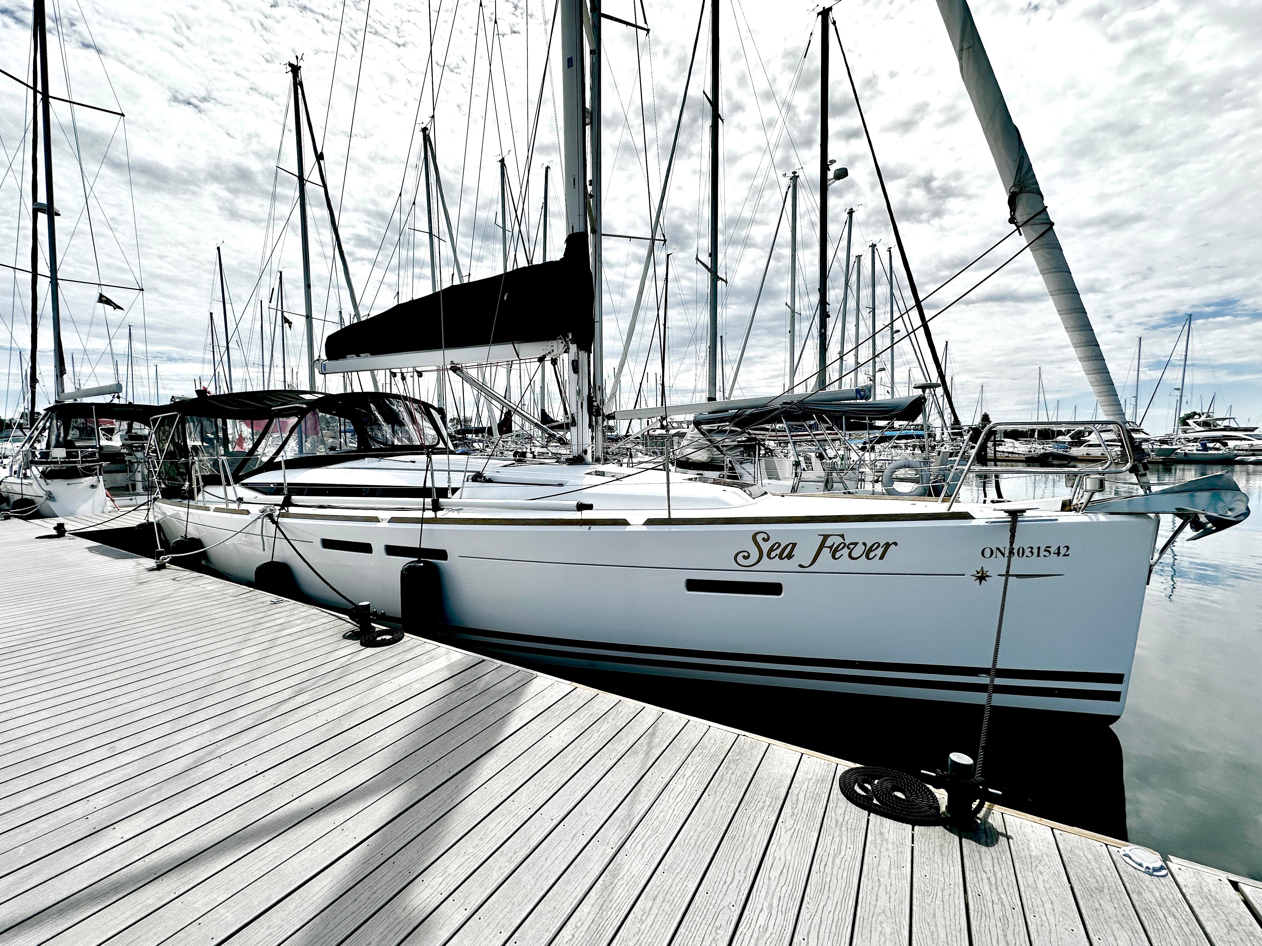 Jeanneau Sun Odyssey 409 2011 Jeanneau Sun Odyssey 409 sailboat docked at marina under cloudy sky.