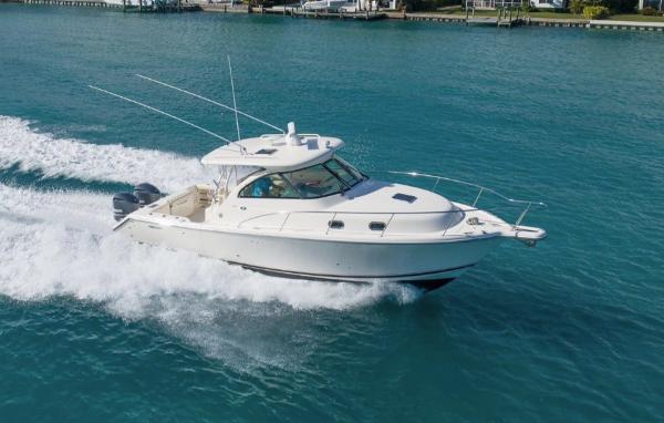 Pursuit OS 345 Offshore 2014 Pursuit OS 345 Offshore boat cruising on clear blue water.