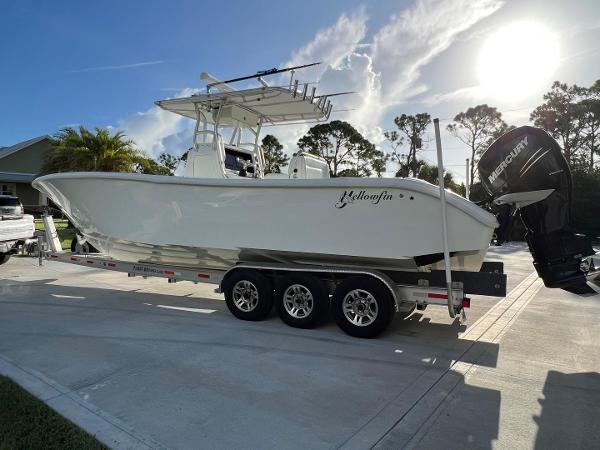 Yellowfin 32 Offshore 2016 Yellowfin 32 Offshore boat on trailer, parked outdoors under a sunny sky.