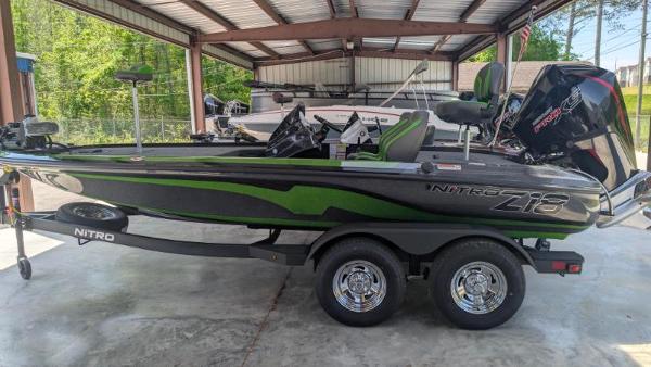 Nitro Z18 Pro 2025 Nitro Z18 Pro boat in a garage, featuring sleek design and dual-axle trailer.