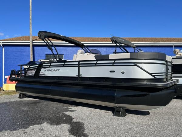 Starcraft CX 23 DL BAR 2025 Starcraft CX 23 DL BAR pontoon boat, silver and black, parked outdoors.