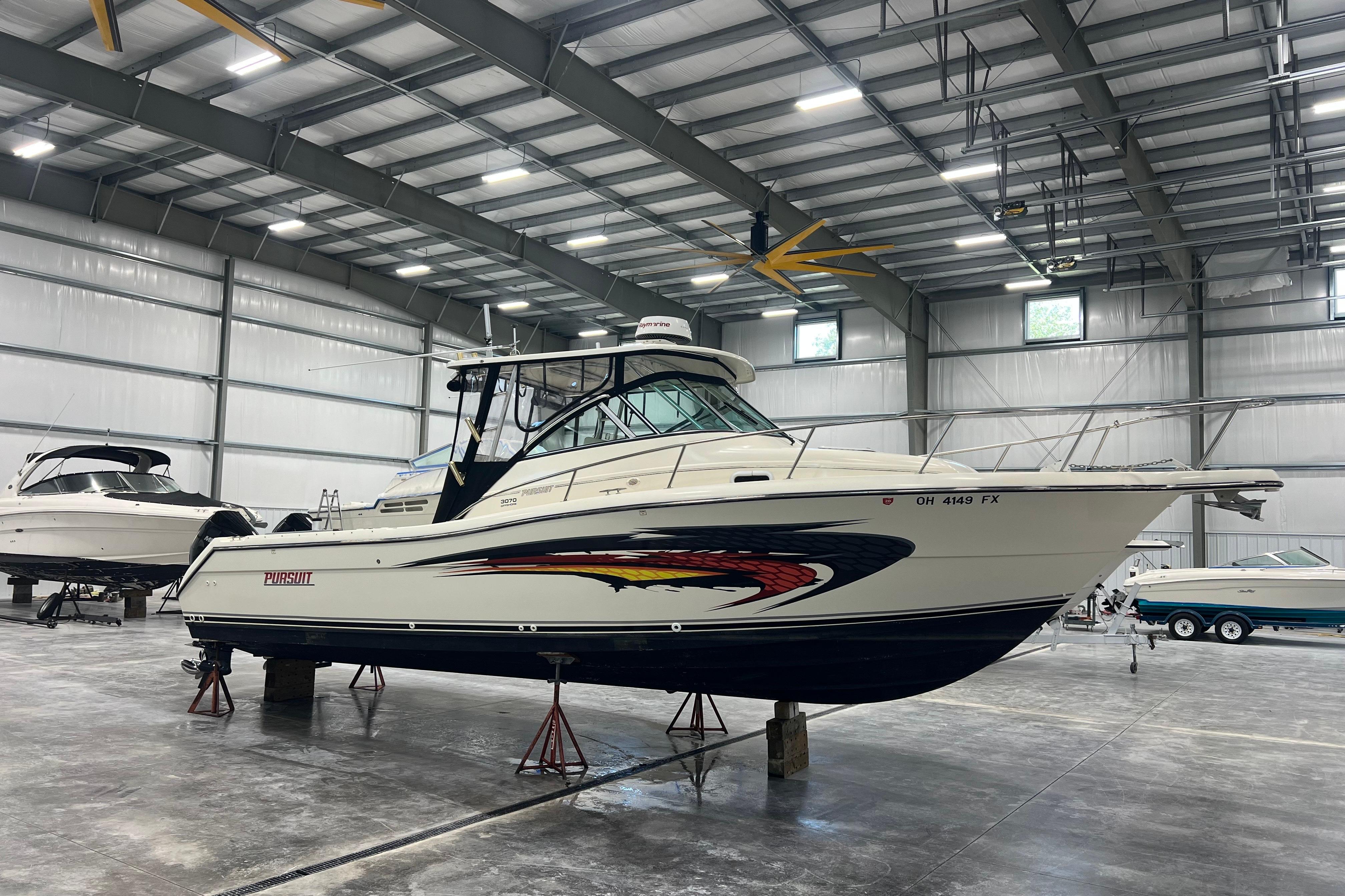 Pursuit 3070 Offshore 2001 Pursuit 3070 Offshore boat in a spacious indoor storage facility.