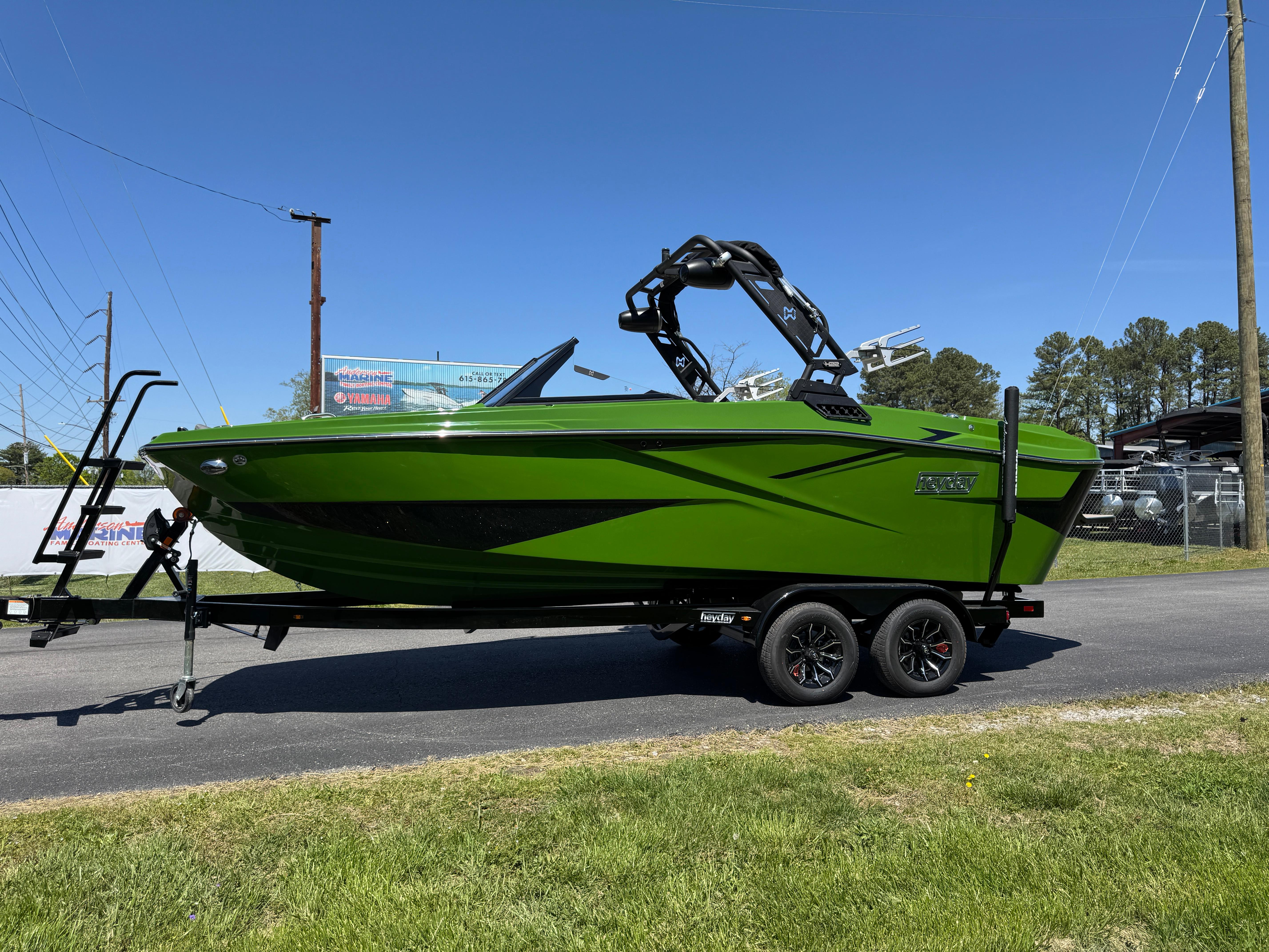 Heyday H22 2025 Heyday H22 boat in vibrant green on a trailer, parked outdoors.