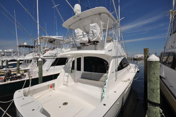 Viking 44 Convertible 2019 Viking 44 Convertible yacht docked at marina under clear blue sky.