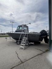 Boston Whaler 27 Vigilant 2002 Boston Whaler 27 Vigilant boat on trailer with ladder, parked outdoors under cloudy sky.