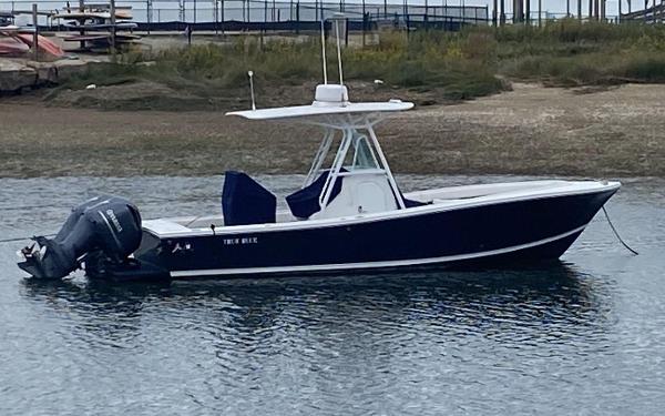 Regulator 26 Forward Seating 2013 Regulator 26 FS boat with twin engines, anchored in calm waters.