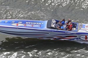 Cigarette 46 2006 Cigarette 46 powerboat with passengers, cruising on water, featuring vibrant American-themed design.