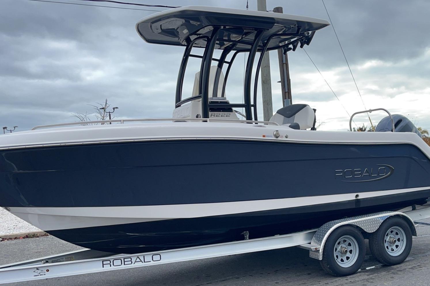 Robalo R222 Center Console 2022 Robalo R222 Center Console boat on trailer, under cloudy sky.