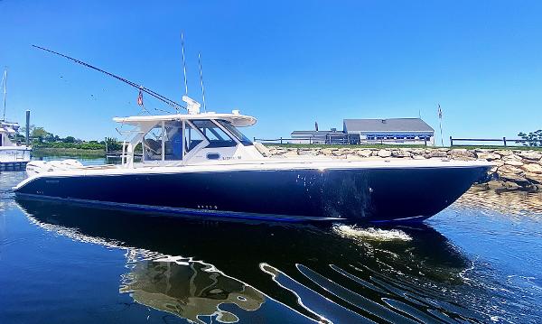 Pursuit S 408 Sport 2019 Pursuit S 408 Sport boat on calm water, clear blue sky background.