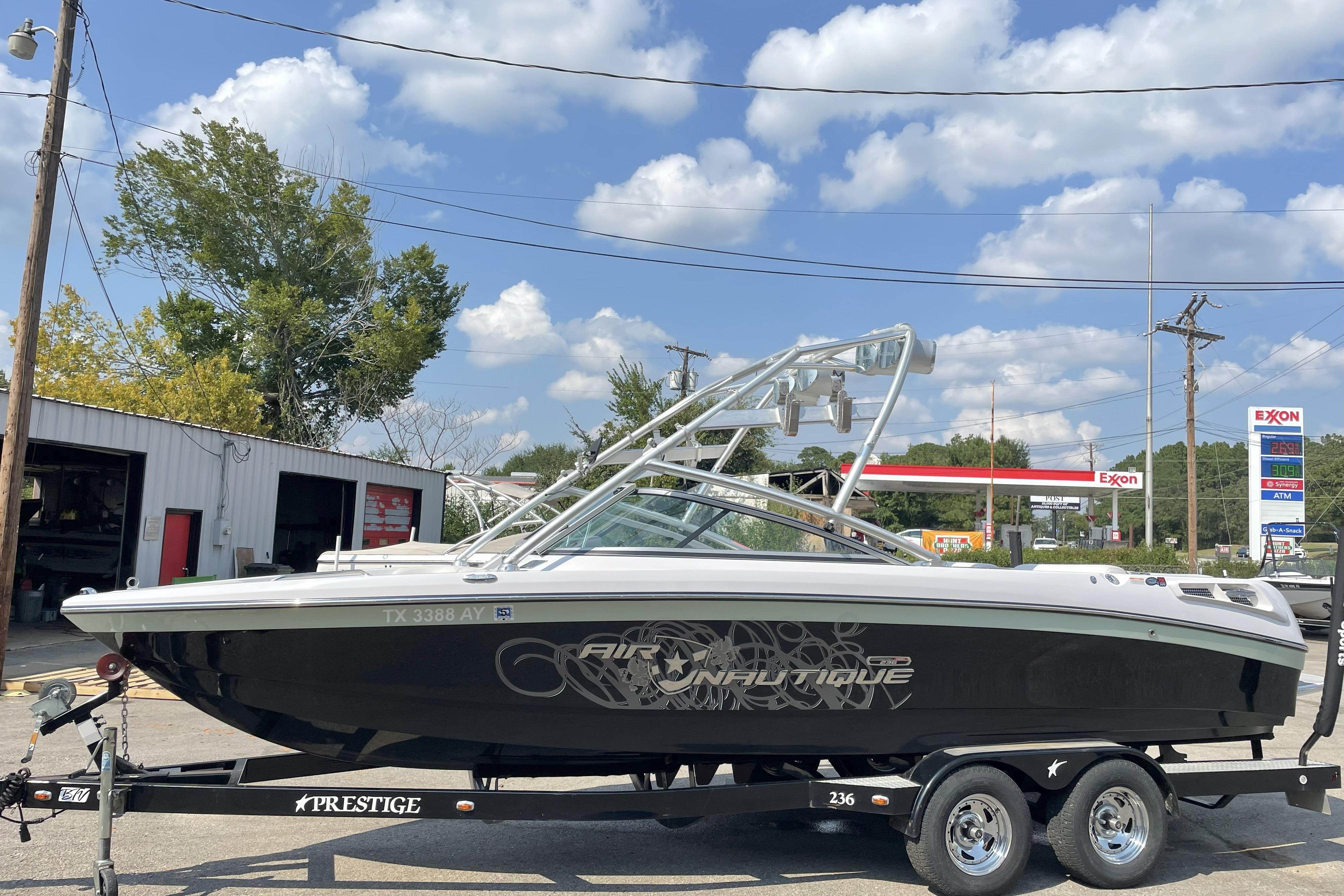 Nautique Super Air Nautique 230 2009 Nautique Super Air Nautique 230 boat on trailer, parked outdoors.