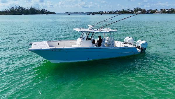 World Cat 400 CC-X 2022 World Cat 400 CC-X boat on turquoise water, featuring quad engines and joystick control.