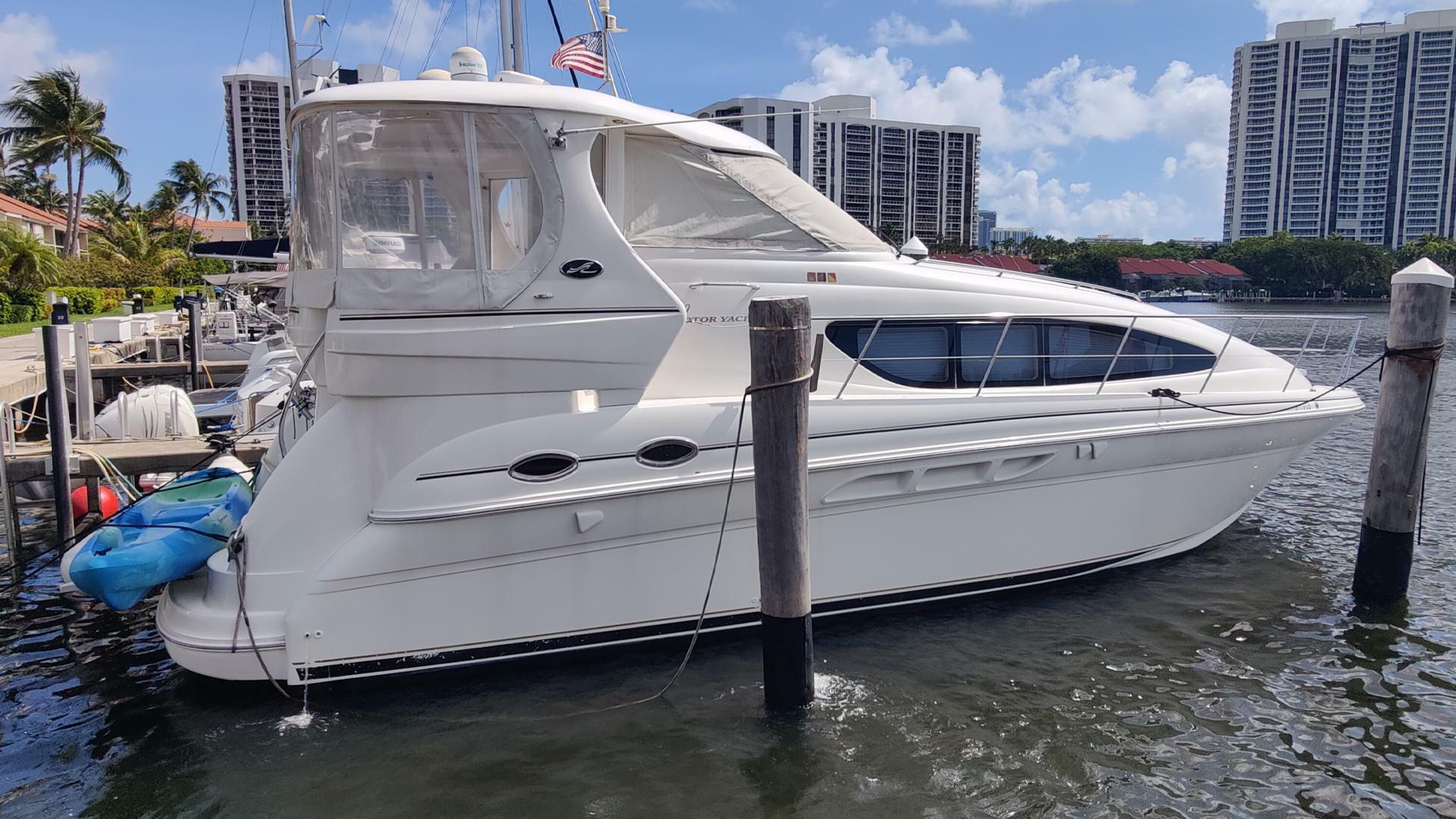 Sea Ray 390 Motor Yacht 2003 Sea Ray 390 Motor Yacht docked in a marina with cityscape background.