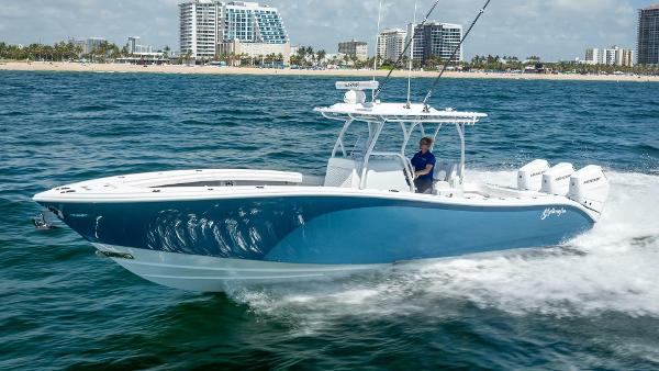 Yellowfin 34 Offshore 2025 Yellowfin 34 Offshore boat cruising on ocean near city skyline.