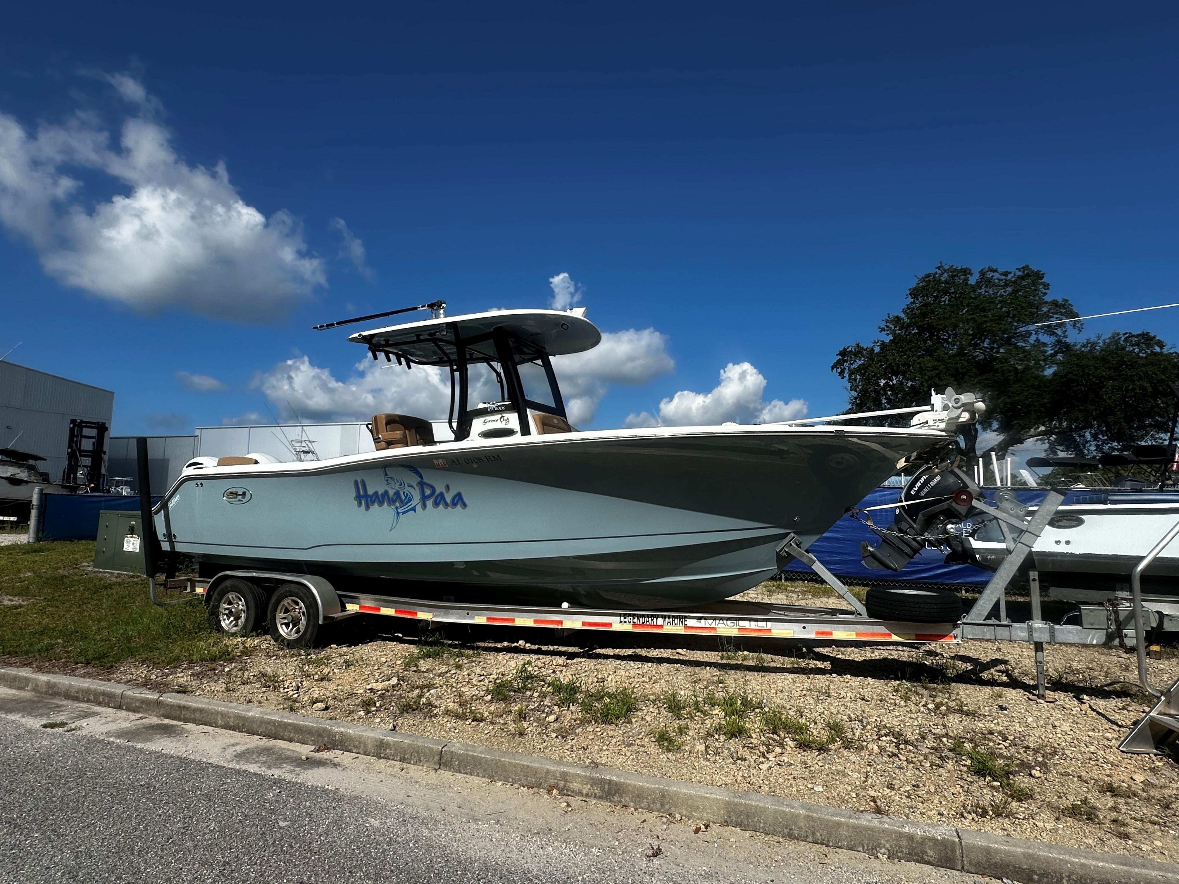 Sea Hunt Gamefish 27 Coffin Box 2020 Sea Hunt Gamefish 27 Coffin Box boat on trailer under blue sky.