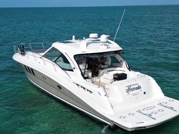 Sea Ray 48 Sundancer 2005 Sea Ray 48 Sundancer yacht cruising on clear blue water.
