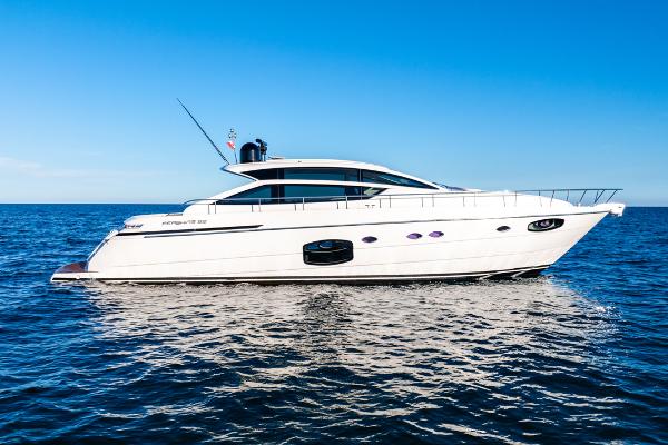 Pershing 62 2021 Pershing 62 yacht cruising on open sea under clear blue sky.