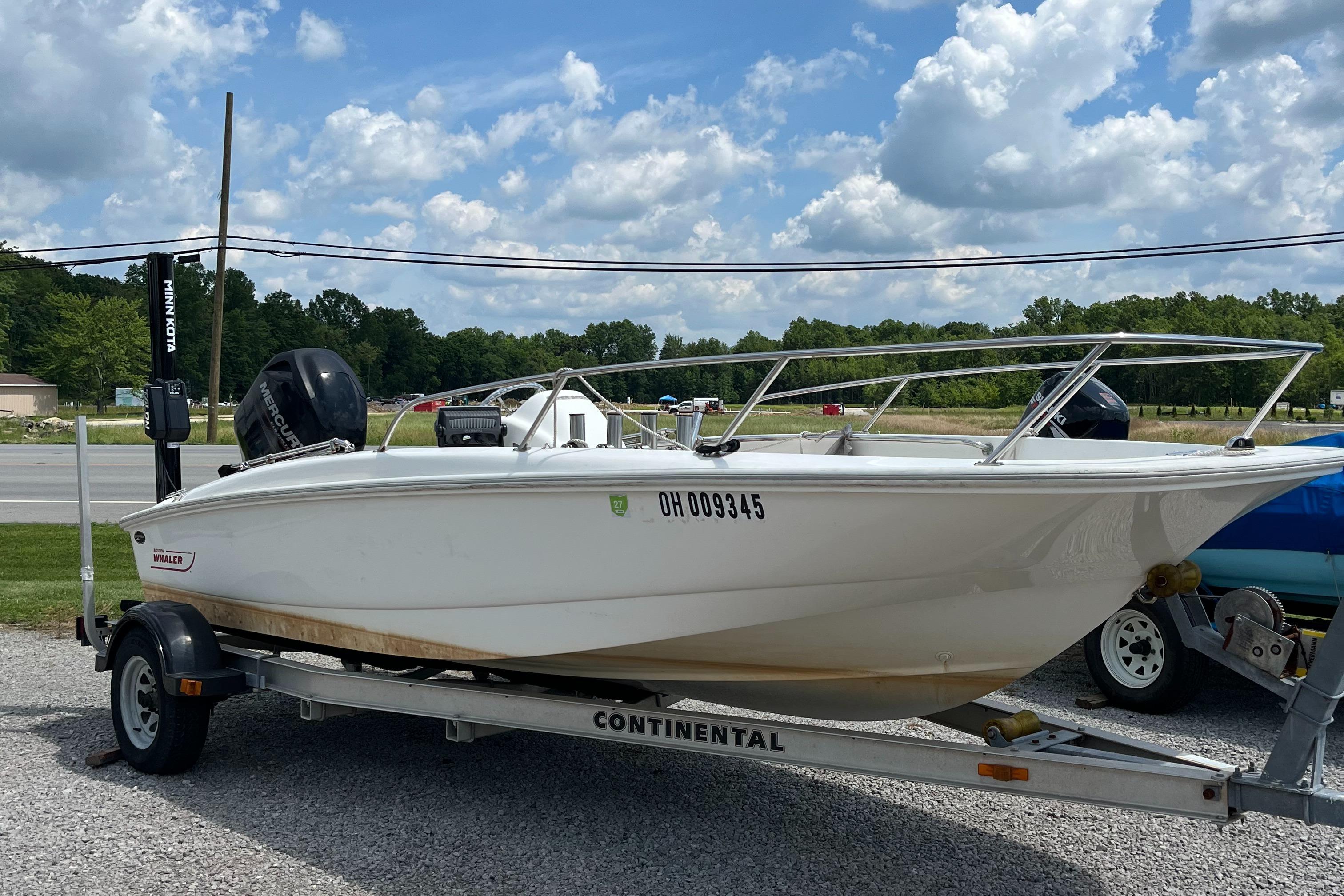 Boston Whaler 170 Super Sport 2012 Boston Whaler 170 Super Sport boat on trailer, parked outdoors under a cloudy sky.