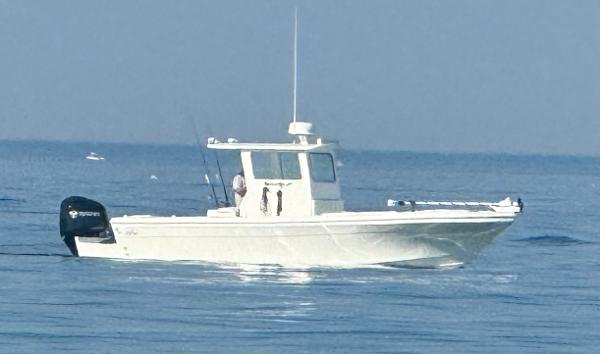 Cape Codder Custom 26 2024 Cape Codder Custom 26 boat cruising on calm ocean waters.